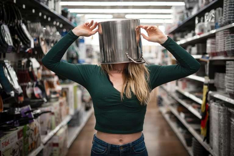 woman with saucepan over her head